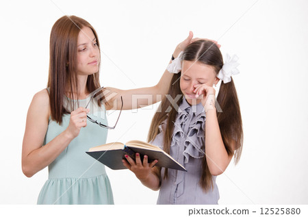 Teacher calms distressed student 12525880