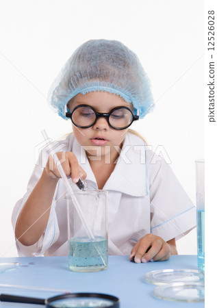 Girl chemist pours reagent into the flask with liquid Girl chemist pours reagent into the flask with liquid 12526028