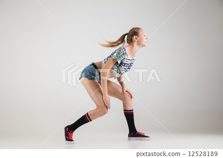 Beautiful booty dancer posing on studio background 12528189