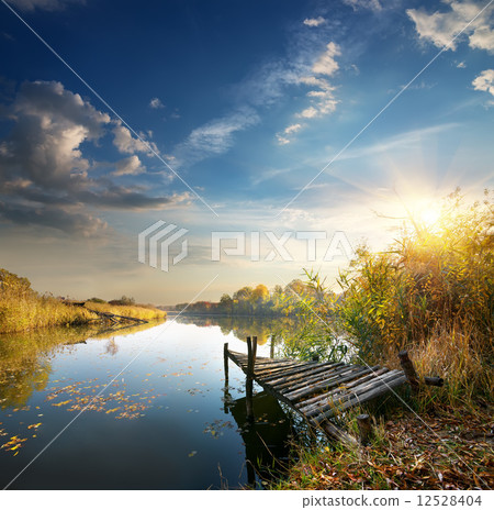Old pier on autumn river Old pier on autumn river 12528404