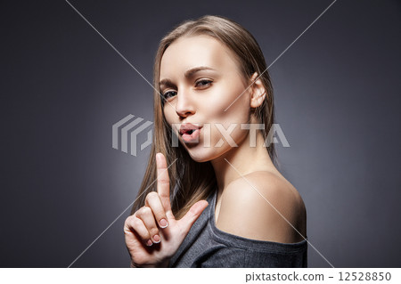Woman pretending to shoot with her finger 12528850