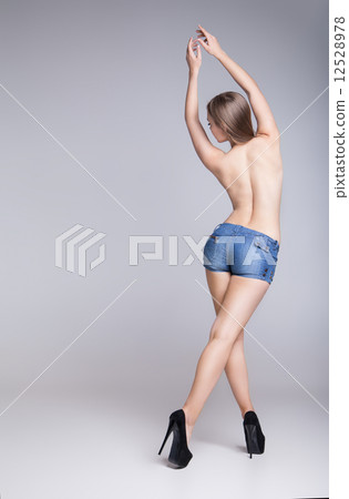 Rear view of sexy woman in jean shorts 12528978