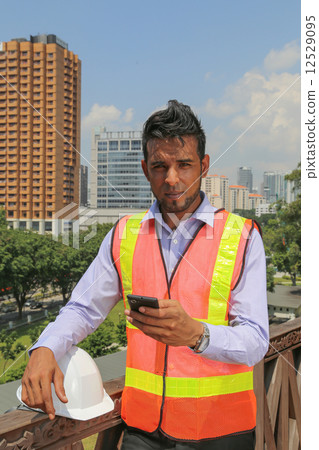 Construction engineer using smart phone Construction engineer using smart phone 12529095
