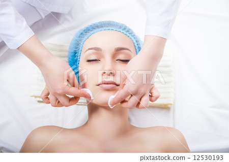 Skin care - woman cleaning face by beautician 12530193