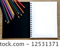 Blank paper and colorful pencils on the wood table - Top view 12531371