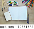 Blank paper, Acrylic paint and colorful pencils on the wood tabl 12531372