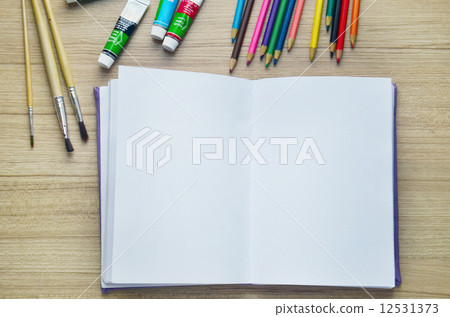 Blank paper, Acrylic paint and colorful pencils on the wood tabl Blank paper, Acrylic paint and colorful pencils on the wood tabl 12531373