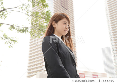 A business woman standing in an office town 12533859