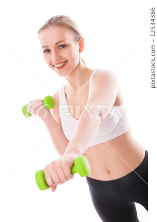 Athletic woman pumping up muscles with dumbbells 12534366