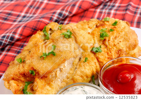 White plate with fried fish, mayonnaise and ketchup 12535823