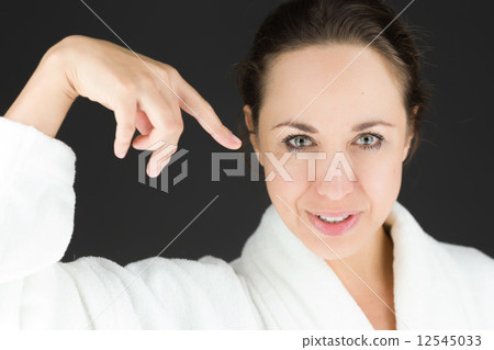 model isolated on plain background pointing to herself 12545033