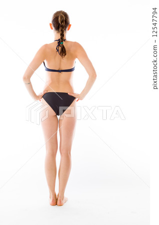 model isolated on plain background back hands on hips 12547794