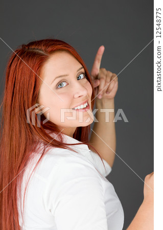 model isolated on plain background looking at camera pointing model isolated on plain background looking at camera pointing 12548775