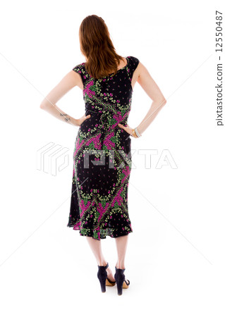 model isolated on plain background back hands on hips 12550487