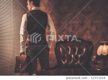 Well-dressed man with a briefcase Well-dressed man with a briefcase 12551816