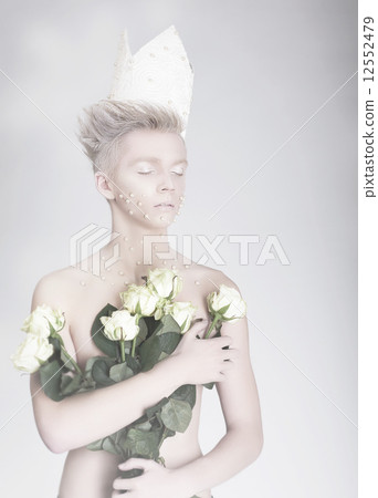 Artistry. Trendy Young Man in Paper Crown with Flowers 12552479
