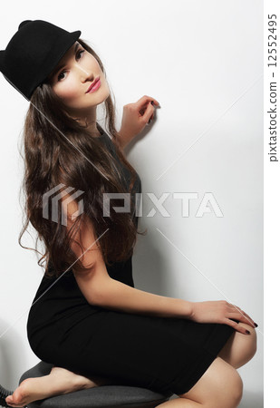 Authentic Woman in Black Dress and Woolen Cap 12552495