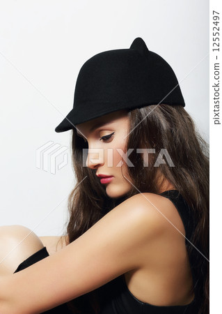 Sophisticated Snazzy Lady in Woolen Cap Sitting 12552497
