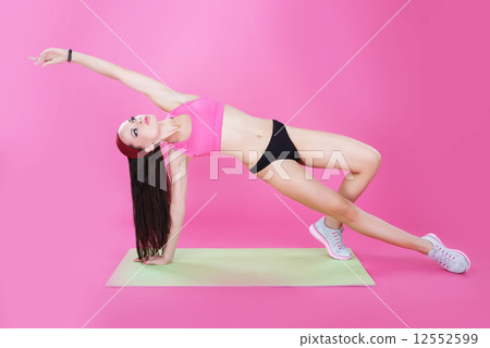 Gymnastics. Fitness. Athletic Woman Stretching on a Mat 12552599