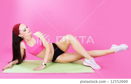 Gymnastics. Abdominal Exercise. Shapely Woman on a Sport Mat 12552600