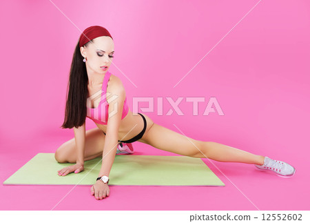 Practice. Athletic Sportswoman is Stretching her Leg. Workout 12552602