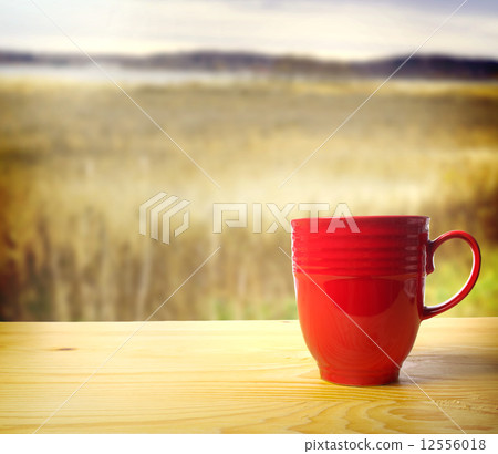 Red mug and natural landscape Red mug and natural landscape 12556018