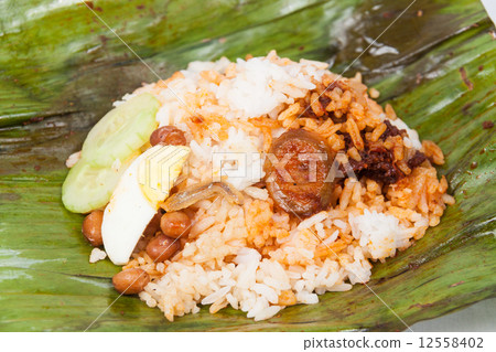 Content of the simple and original traditional banana leaf wrapped nasi lemak. Content of the simple and original traditional banana leaf wrapped nasi lemak. 12558402