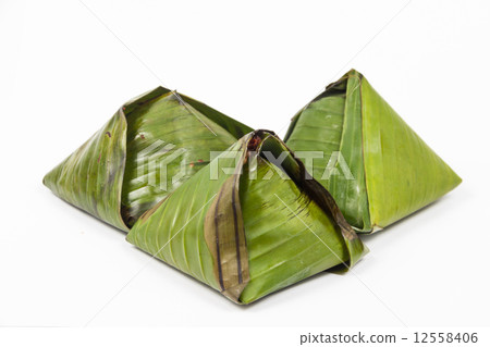 3 unopened simple traditional and original nasi lemak wrapped in banana leaf. 12558406