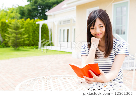 A woman relaxing in the garden A woman relaxing in the garden 12561305