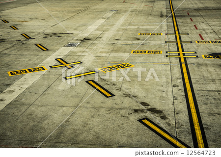 black and yellow airport markings on concrete black and yellow airport markings on concrete 12564723