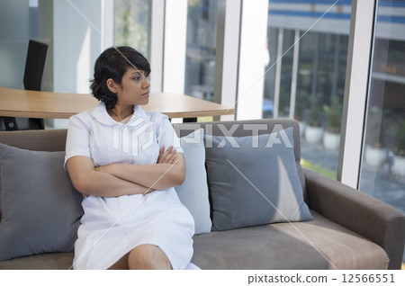 Young Asian nurse coming down with a migraine. 12566551