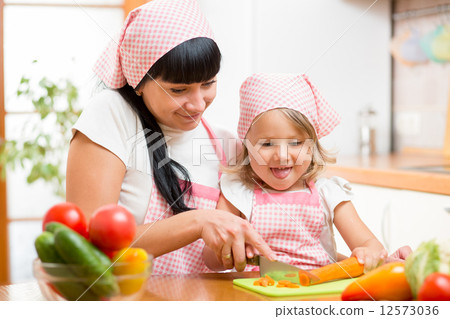 mom and child preparing healthy food at kitchen mom and child preparing healthy food at kitchen 12573036