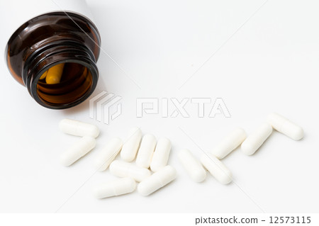 Pills spilling out of pill bottle Pills spilling out of pill bottle 12573115