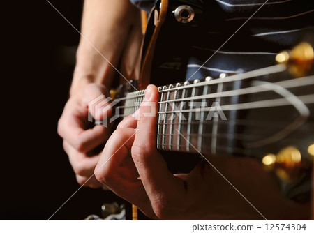 guitarist hands playing guitar over black guitarist hands playing guitar over black 12574304