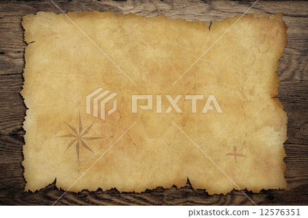 Pirates' old parchment treasure map on wood table 12576351