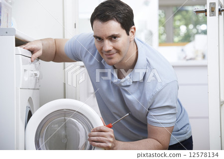 Engineer Mending Domestic Washing Machine 12578134
