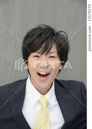 Businessman model standing in the office area Model: Suzuki Snow 12579370