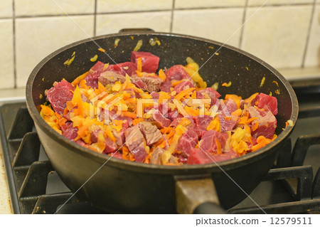 Cooking Meat in a Pan With Vegetables Cooking Meat in a Pan With Vegetables 12579511