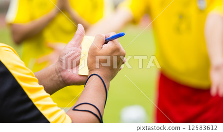 Referee soccer show card for warning and  recorded player foul Referee soccer show card for warning and  recorded player foul 12583612