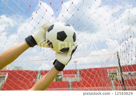 Goalkeeper used hands for catches the ball Goalkeeper used hands for catches the ball 12583629