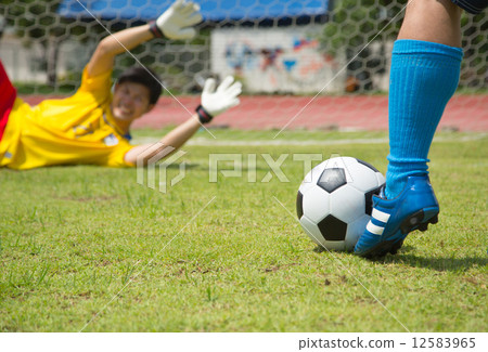 Attack soccer player shooting to defense team Attack soccer player shooting to defense team 12583965