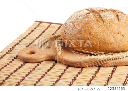 A loaf of bread on a board 12584663