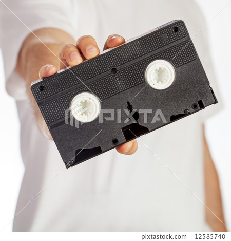 VHS cassette hold by hand 12585740