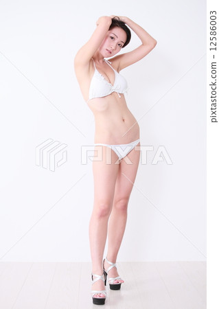 A young woman in a bathing suit 12586003