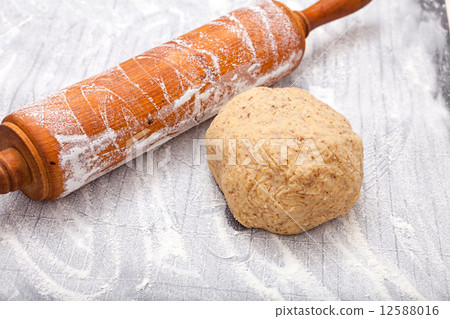 Wooden rolling pin and a dough ball 12588016