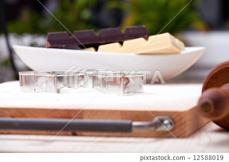 Cookie cutters and white and dark couverture 12588019