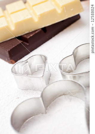 Cookie cutters and white and dark couverture 12588024