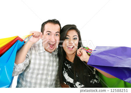 Happy couple with shopping bags isolated on white Happy couple with shopping bags isolated on white 12588251