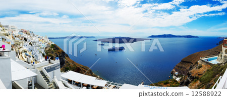The view on Fira town and tourists enjoying their vacation, Greece 12588922