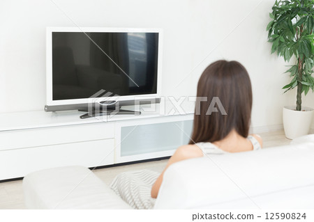A woman watching TV 12590824